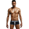 Daily wear|Gym sessions|Holiday parties|Pride events|Night gatherings|Breathable|Butt-lift design|Snug fit|Lightweight|Shaping|Waistline control|Slimming|Abdomen control|Comfort|Proper support|Stylish appearance|Festive mood|Body sculpting|Men's trunks|Low-rise underwear|Polyester pouch trunks|Sexy trunks|Open-back trunks|Black|Front view